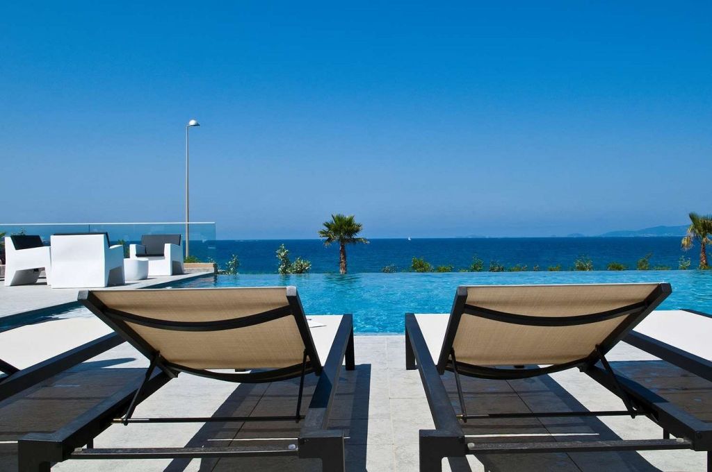 two lounge chairs by the pool